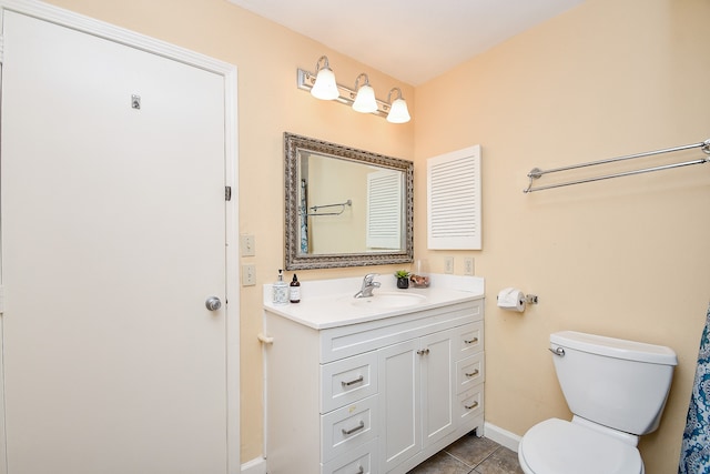 bathroom featuring toilet, tile patterned floors, and vanity