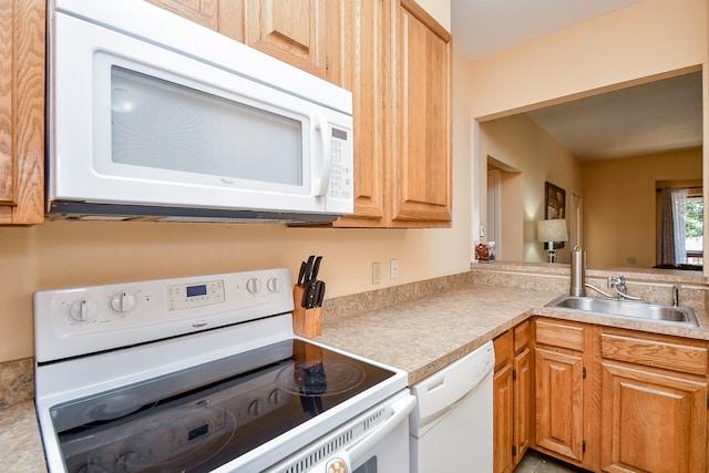 kitchen with white appliances and sink