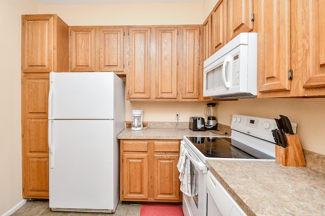 kitchen with white appliances and light tile patterned floors