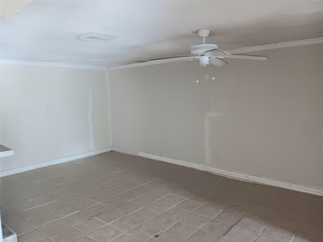 spare room with baseboards, visible vents, a ceiling fan, and crown molding