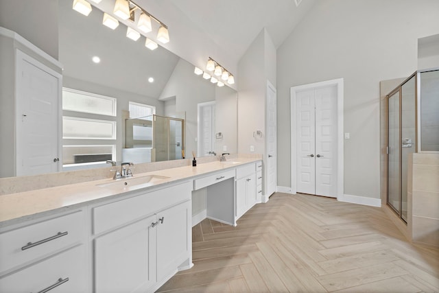 bathroom featuring vanity, parquet flooring, an enclosed shower, and high vaulted ceiling