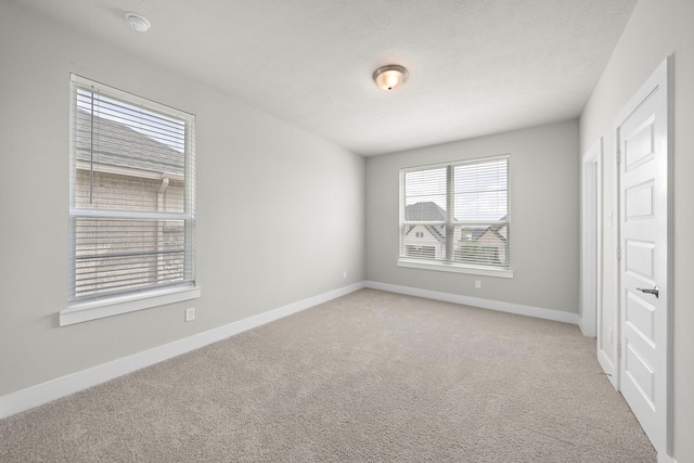 unfurnished room with light colored carpet