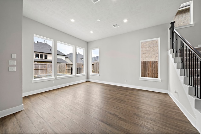 unfurnished living room featuring dark wood-type flooring