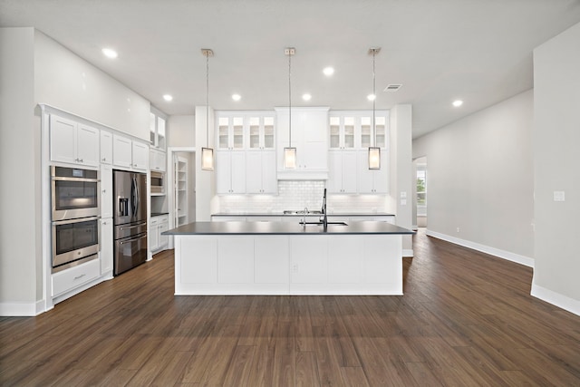 kitchen with white cabinetry, appliances with stainless steel finishes, and decorative light fixtures