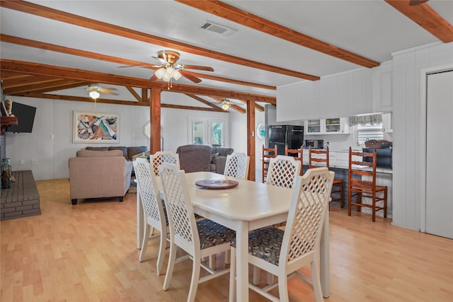 dining space with beamed ceiling, ceiling fan, and light hardwood / wood-style floors