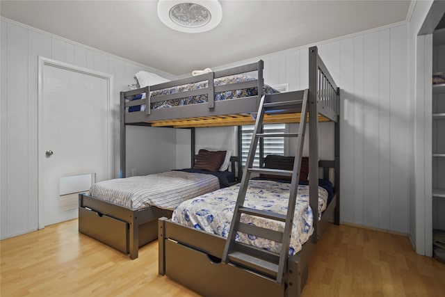 bedroom featuring light wood-type flooring and ornamental molding