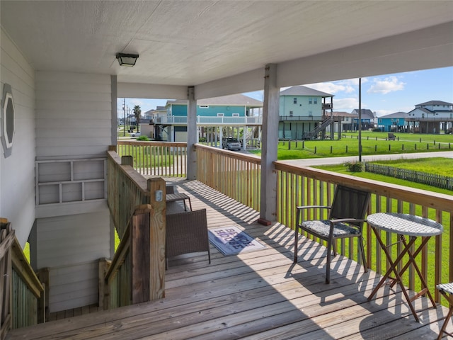 wooden terrace with a lawn