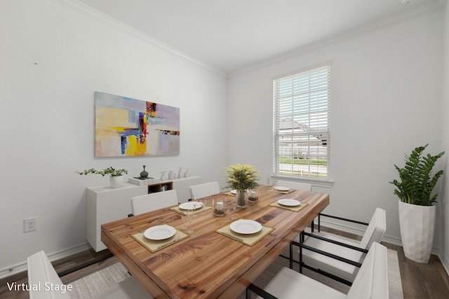 dining space with hardwood / wood-style floors and ornamental molding