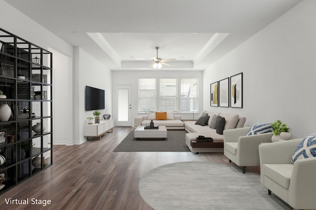 living room featuring a raised ceiling, ceiling fan, and hardwood / wood-style flooring