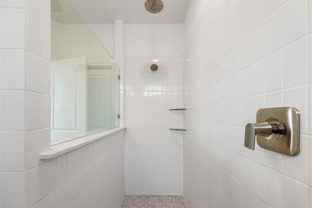 bathroom with tiled shower