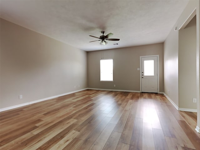 unfurnished room featuring ceiling fan and light hardwood / wood-style flooring