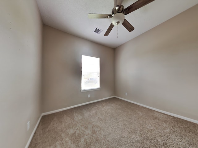 carpeted spare room featuring ceiling fan