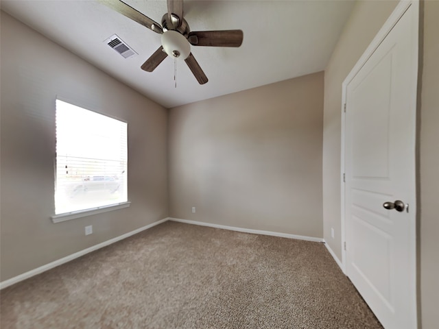 unfurnished room featuring ceiling fan and carpet