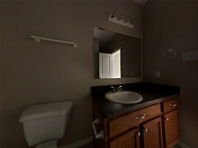 bathroom featuring vanity and toilet