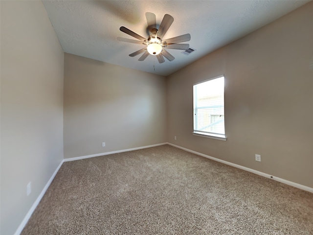 unfurnished room featuring ceiling fan and carpet