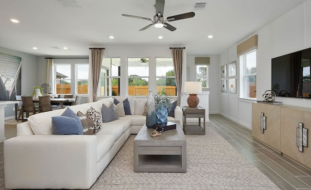 living room with ceiling fan and light hardwood / wood-style flooring