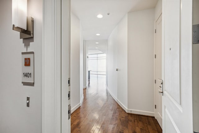 corridor with recessed lighting, baseboards, and wood finished floors