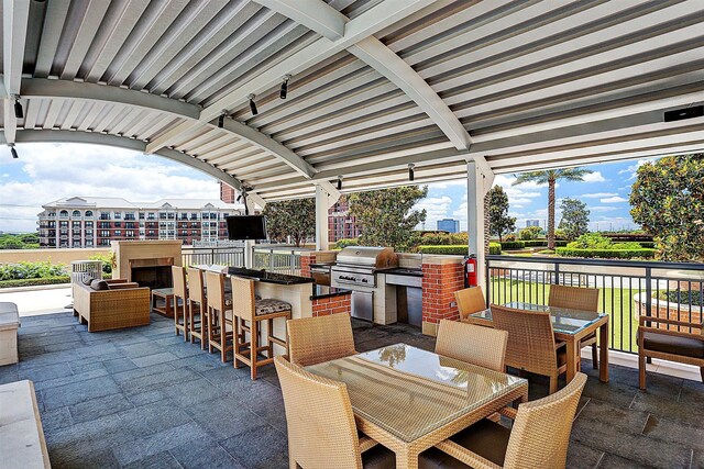 view of patio with area for grilling, an outdoor bar, and grilling area