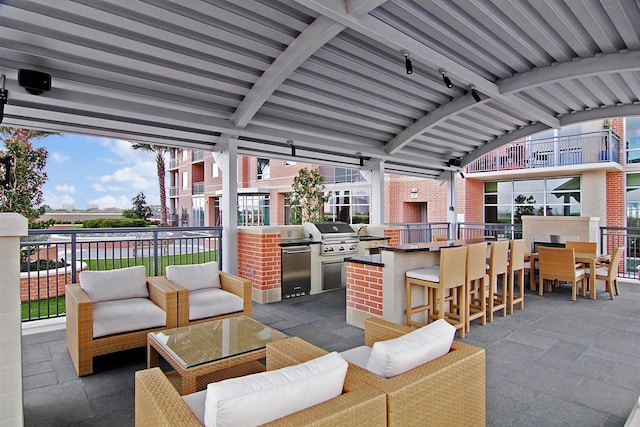 view of patio featuring outdoor wet bar, outdoor lounge area, and area for grilling