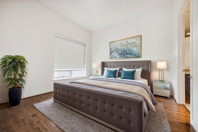 bedroom with dark hardwood / wood-style flooring