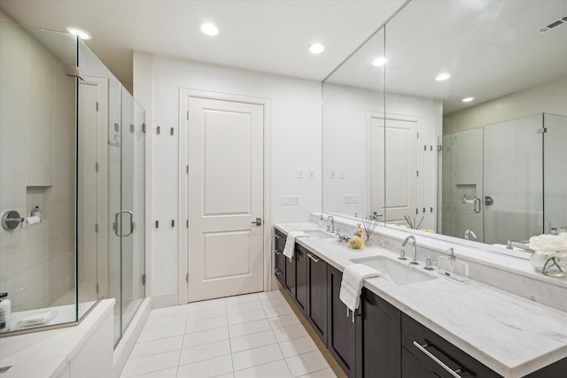 bathroom with a stall shower, visible vents, a sink, and double vanity