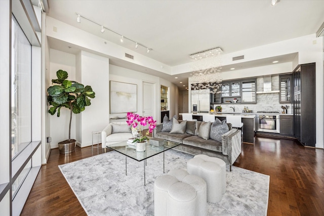 living room with dark wood-type flooring, visible vents, and recessed lighting