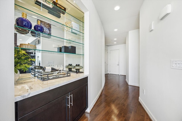 bar with dark wood-style floors, recessed lighting, and baseboards