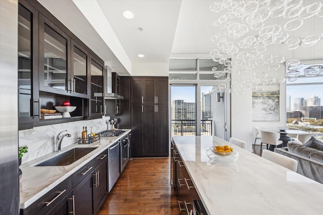 kitchen featuring appliances with stainless steel finishes, dark wood finished floors, a city view, and a sink