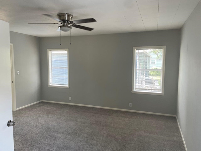 carpeted spare room featuring ceiling fan