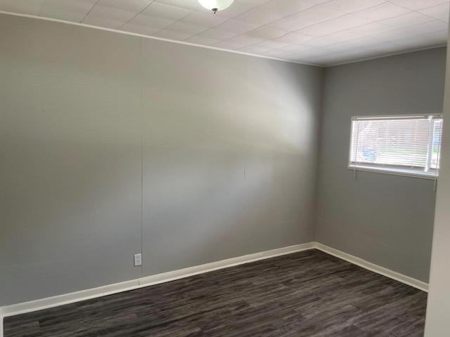 spare room with dark hardwood / wood-style flooring