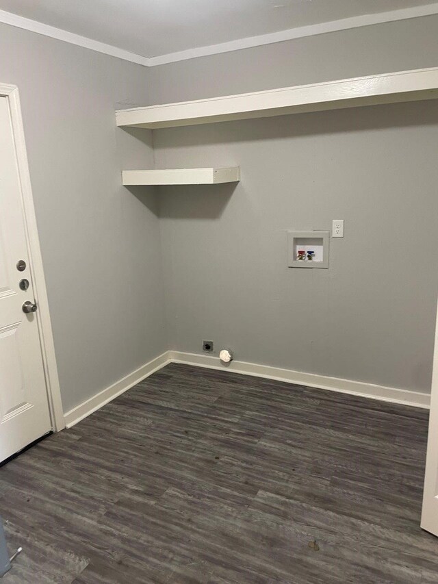 clothes washing area with dark wood-type flooring, washer hookup, and ornamental molding