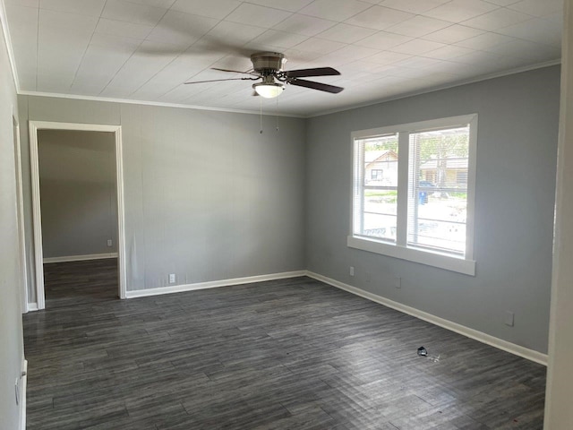 spare room with ceiling fan, ornamental molding, and dark wood-type flooring