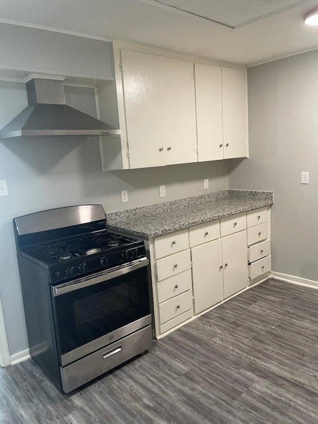 kitchen with white cabinetry, light stone countertops, stainless steel gas range, dark wood-type flooring, and wall chimney exhaust hood