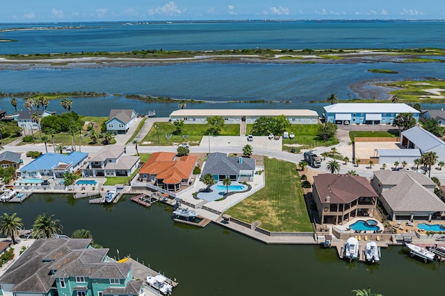 drone / aerial view with a residential view and a water view