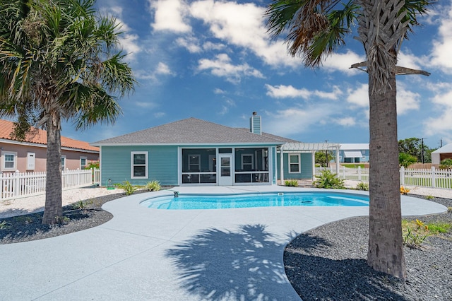 view of swimming pool featuring a fenced in pool, a sunroom, and fence