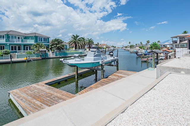 view of dock featuring a residential view, a water view, and boat lift