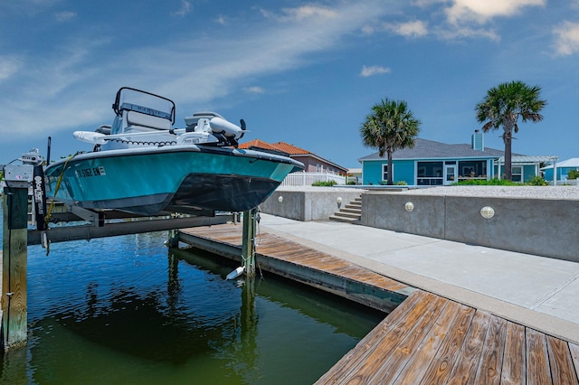 dock area with a water view and boat lift