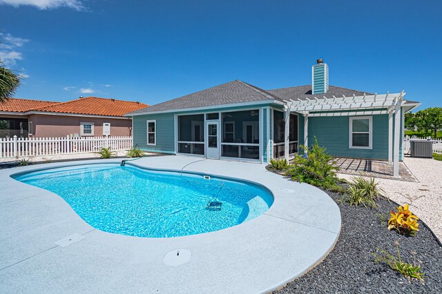 view of pool featuring a pergola, a sunroom, and a patio