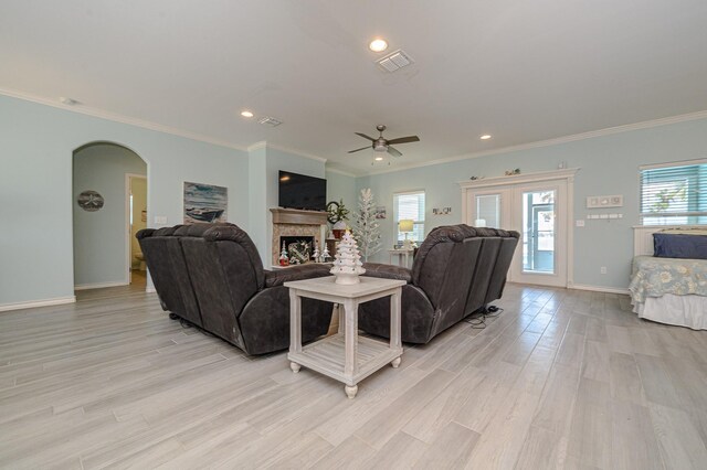 living room with light hardwood / wood-style floors, ceiling fan, and a healthy amount of sunlight