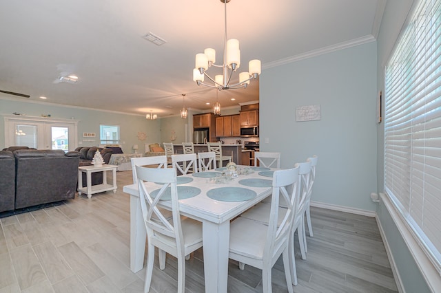 dining area with a chandelier, ornamental molding, and light hardwood / wood-style floors