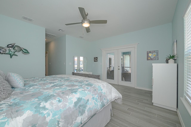 bedroom with access to exterior, wood finish floors, french doors, visible vents, and ceiling fan