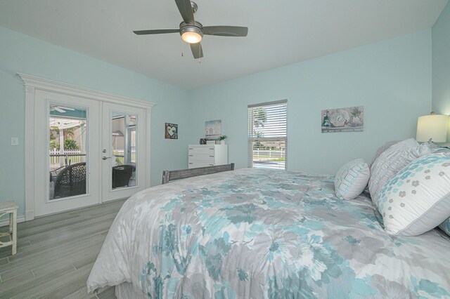 bedroom with ceiling fan, access to exterior, light wood-type flooring, and french doors