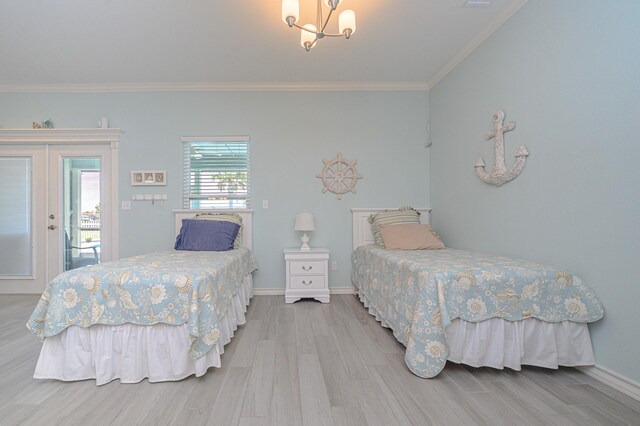 bedroom featuring access to outside, light wood-type flooring, ornamental molding, and an inviting chandelier