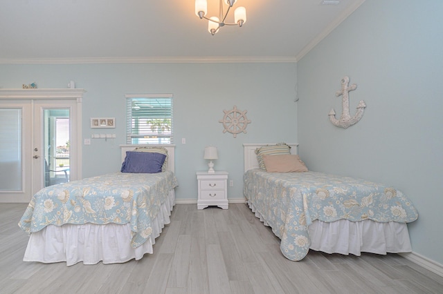 bedroom with light wood finished floors, baseboards, crown molding, and an inviting chandelier