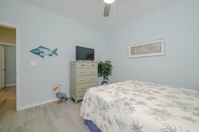 bedroom featuring light wood-style floors, ceiling fan, and baseboards