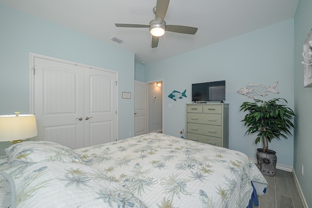 bedroom featuring ceiling fan, light hardwood / wood-style flooring, and a closet