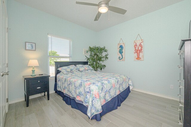 bedroom with ceiling fan and light hardwood / wood-style flooring