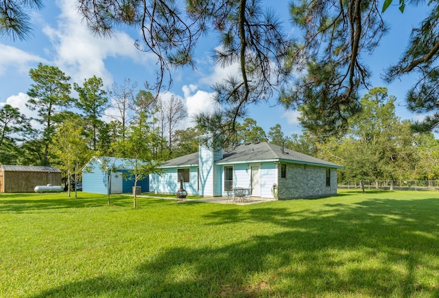 back of house with a yard and a patio area