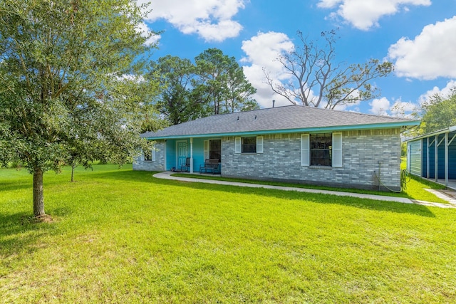 rear view of house with a yard