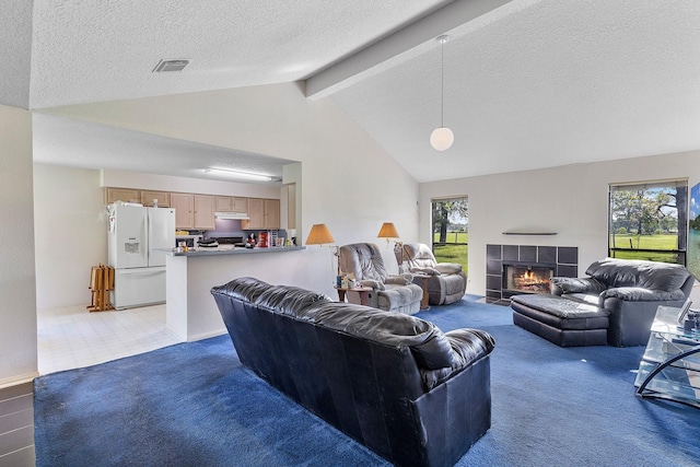 living room featuring a tiled fireplace, high vaulted ceiling, a textured ceiling, and beam ceiling